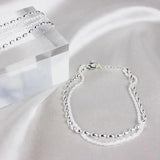 Conjunto de pulseiras elegantes em prata com pedras de zircónio