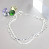 Conjunto de pulseiras elegantes em prata com pedras de zircónio